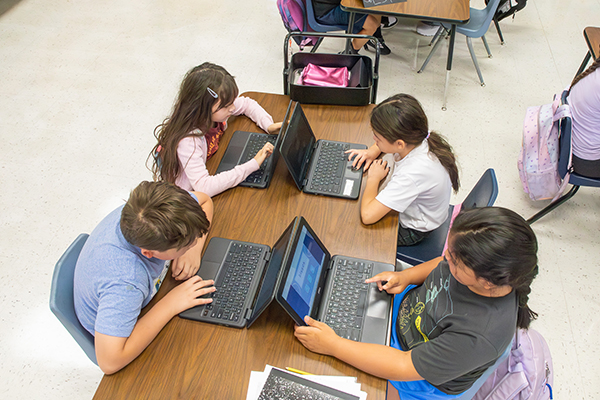 Overhead view of students working on their laptops