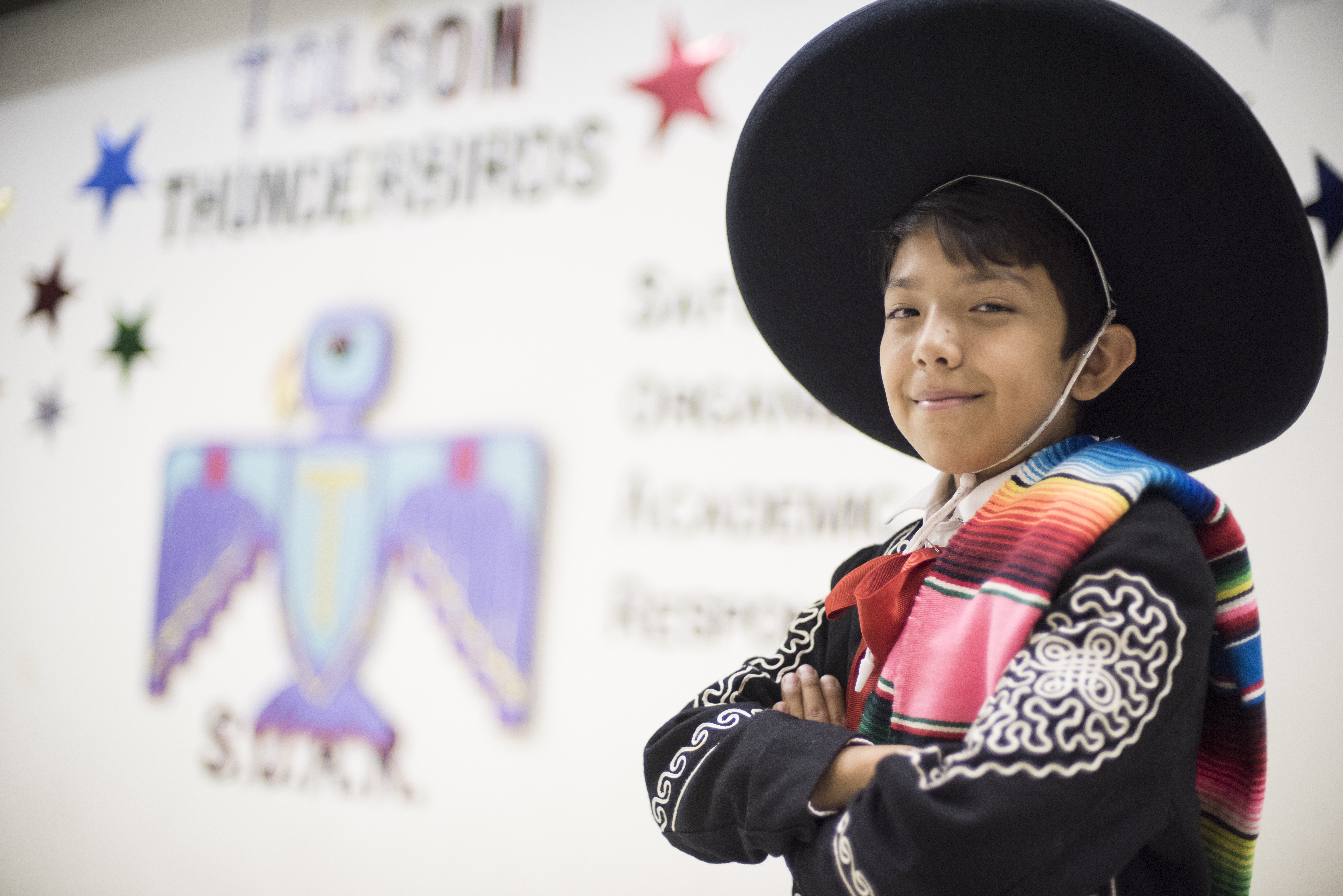 A little boy smiles in his mariachi costume